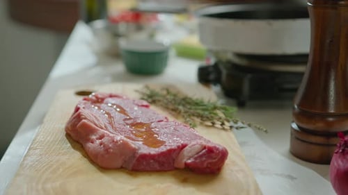 Raw Steak being prepared in a kitchen