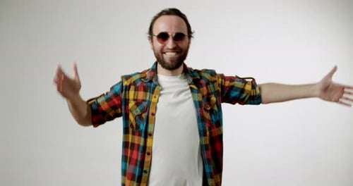 Happy Man Dancing in Colorful Shirt on White Background