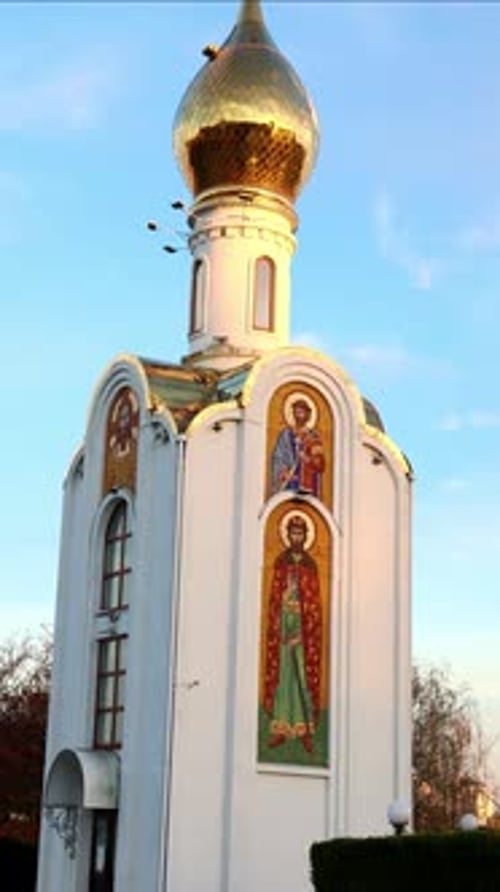 vertical Golden dome of the Orthodox church in Bender, Moldova shining at sunset