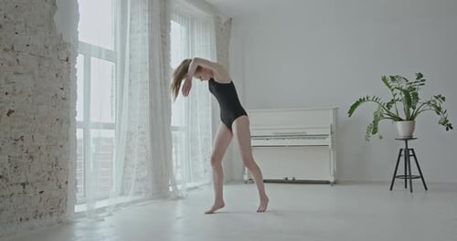 Young Woman Dances Gracefully in Bright Studio