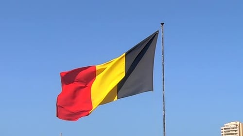 Belgian Flag Waving Against Blue Sky