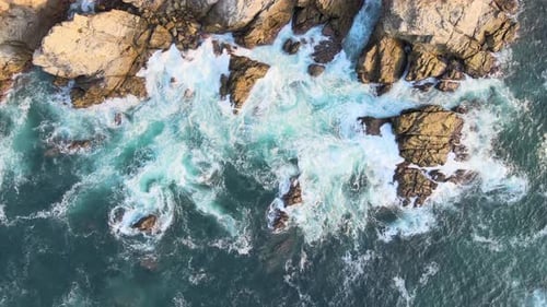 Zenith view above cliff and waves at sunrise in Oaxaca's shore, Mexico