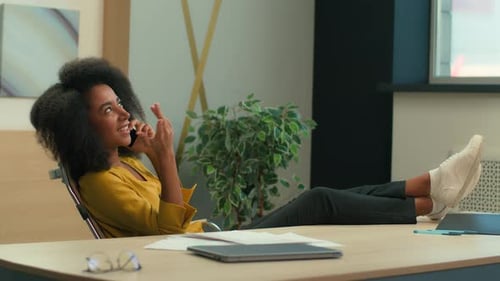 Woman talking on phone in modern office