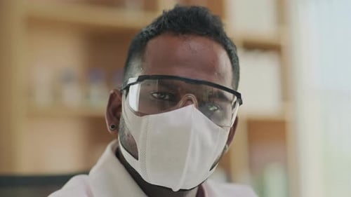 Serious Scientist Wearing Protective Gear in Lab Close Up