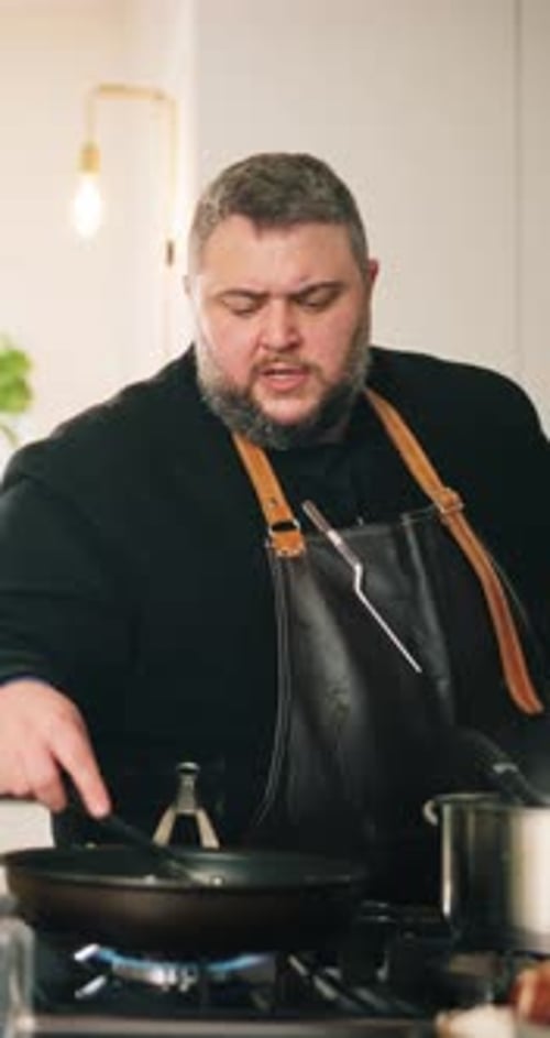 Man Cooking Food in Frying Pan