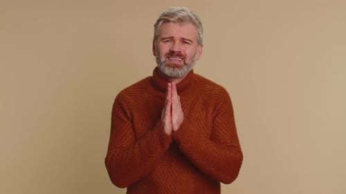 Man Pleading, Hands Pressed Together