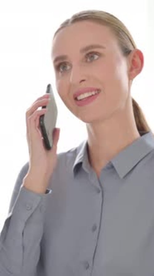 Smiling Woman Talking on Smartphone in Bright Daylight