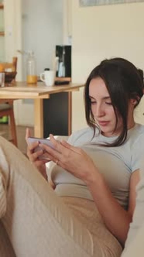 Young Woman Using a Smartphone on Couch