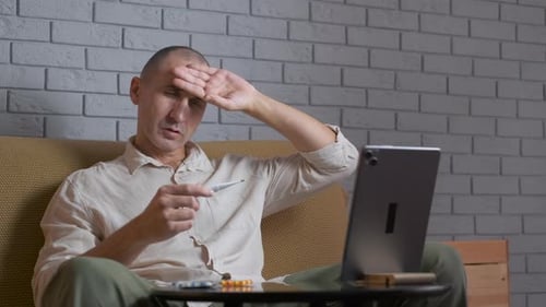 Adult Man Checking Temperature During Telehealth Call