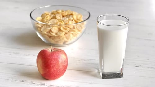 Apple, Cereal and Milk on a Table