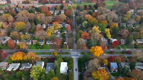 American neighborhood in autumn. Aerial truck shot during fall foliage season. USA suburbs.