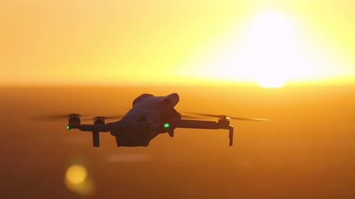 Drone Flying at Golden Hour Above the Horizon