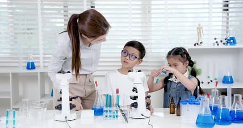 Teacher and Children in a Science Lab Experiment