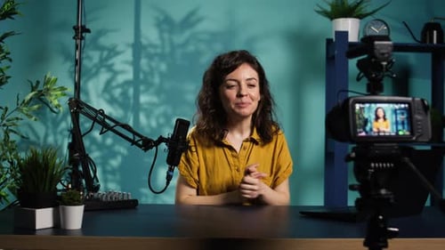 Woman Talking to Camera with Microphone in Studio