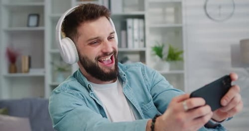 Young Adult Enjoying Phone in a Bright Room