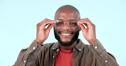 Happy, face and a black man with glasses on a studio background for optometry, frame or a new lens