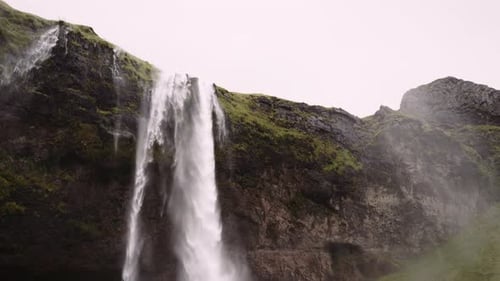 Scenic Waterfall Cascading Down Mossy Cliff