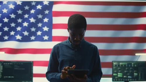 Man Working on Tablet in Control Room