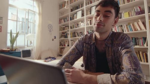 Man Using Laptop for Online Communication at Home