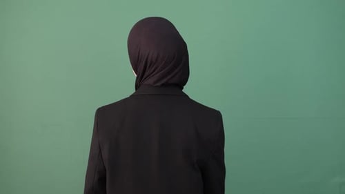 Smiling Woman Points at Camera with Hijab