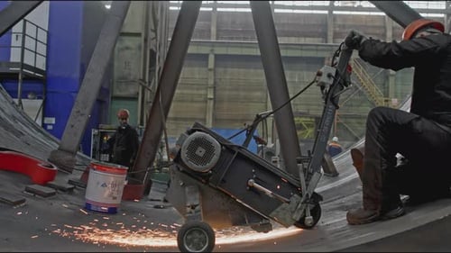 Workers Grind Metal Inside Industrial Equipment