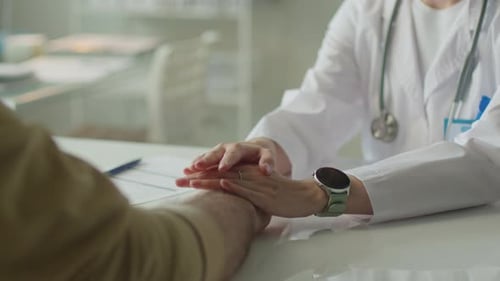 Close-Up of Female Doctor Holding Hands of Patient during Conversation
