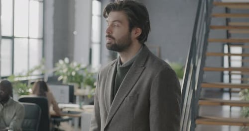 Portrait of Happy Young Man Office Employee Turning to Camera Smiling Crossing Arms Indoors in