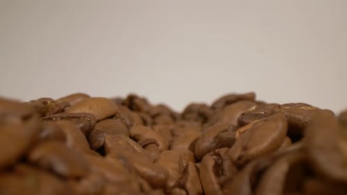 Sliding view of sweet coffee beans. People's addiction to coffee.