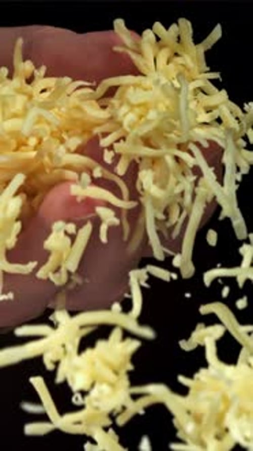 Grated Cheese Falls Out of the Cook's Hand Filmed on a Highspeed Camera at 1000 Fps