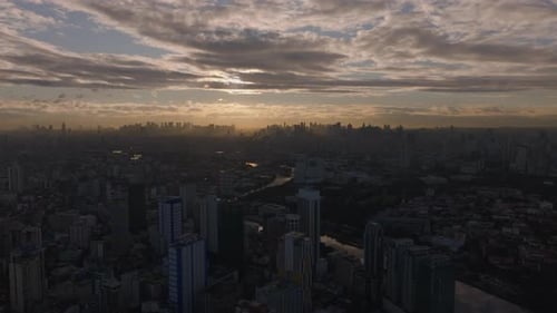 Aerial View of Manila Skyline During Sunset Capturing the City's Urban Landscape Against Dramatic