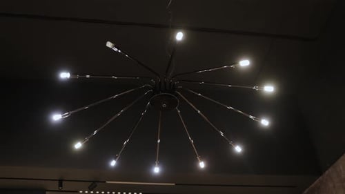 Modern Chandelier with Many Lights on Dark Ceiling