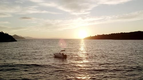 Fisherman with a Boat Out at Sea in the Morning