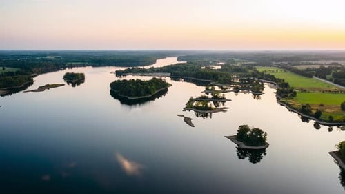 Aerial hyperlapse over the river in dusk. River with islands from above in the evening.