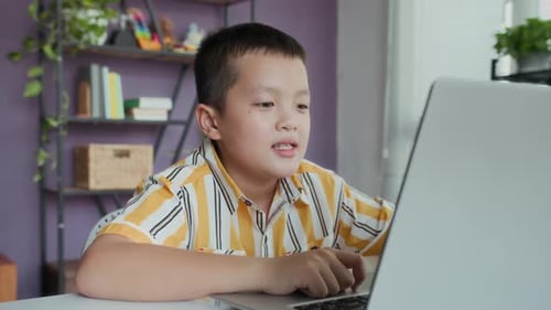 Boy Learning on Laptop Computer at Home