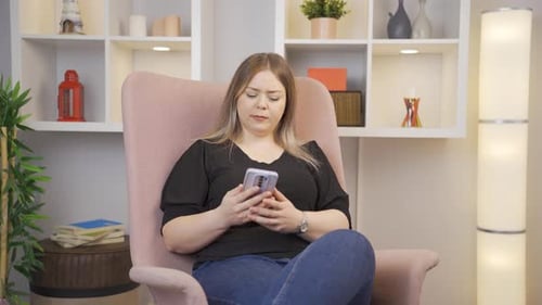 Woman Reacts in Shock to Content on Mobile Phone