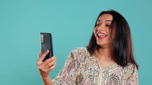 Young Woman Talking and Video Chatting with Phone