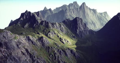 Majestic Mountain Range with Rugged Peaks and Lush Green Valleys in Daylight