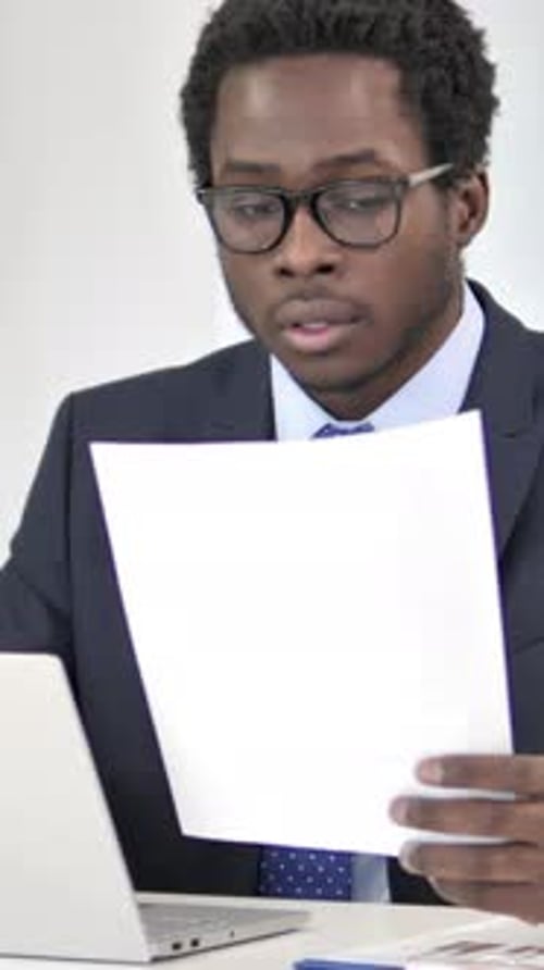 African Businessman Working on Documents in Office, Vertical Video