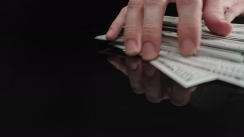 Hands Spread, Gather, and Drop One Hundred Dollar Bills