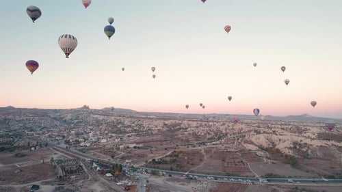 Hot Air Balloons Floating Over Cappadocia Landscape at Sunrise