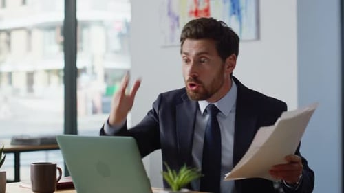Man in Suit Presents During Video Call