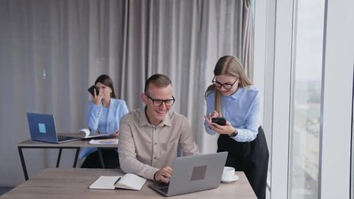 Group of young business managers working in modern office. Project colleagues planning together.