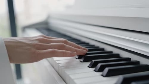 Hands Playing Piano Keys Indoors
