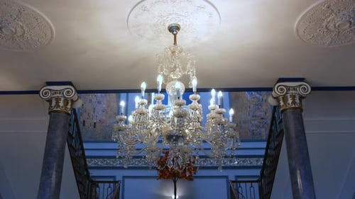 A chandelier in an opulent hotel manor house entrance hall lobby