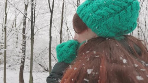 Woman Admiring Snowy Forest in Winter Clothing