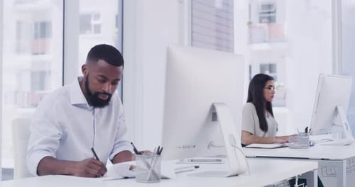 4k video footage of two businesspeople using their computers in a modern office