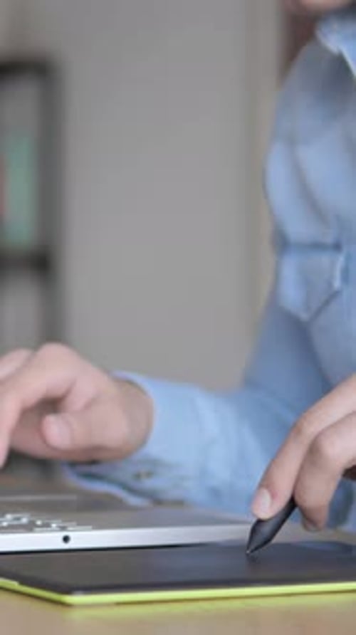 Hands Using Stylus and Laptop for Digital Art