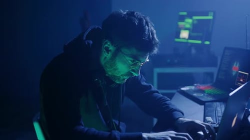 Adult Coding at Computer in Blue Light