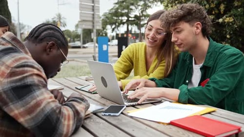 Student Friends Working Together on Laptop Preparing for Exams and School Project