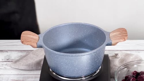 Cooking Pot with Wood Handles Awaits Ingredients